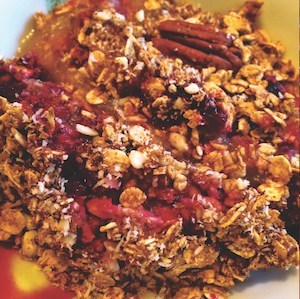 An image of this apple and cherry crumble recipe, in a bowl. 